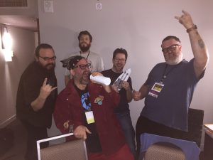 A playtest session at Big Bad Con 2016. The band called themselves BloodBath & Beyond, and their members included Godd Todd on vocal (Todd Evans), Mercurio on double-necked guitar (Jim Dovey), Helmut on bass guitar (Peter Ciccolo), Spider on drums (Mark Malone), and Gogrgor on gong and triangle (Thom Hall).